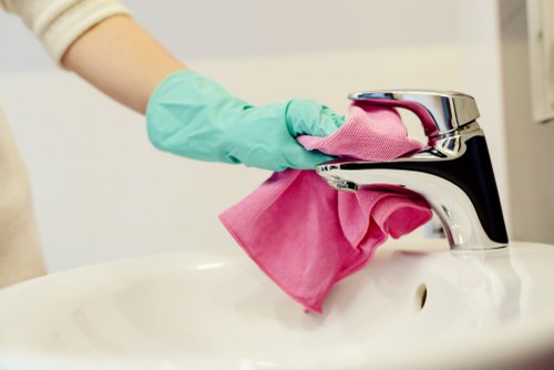 Cleaning operative wearing PPE during carpet cleaning